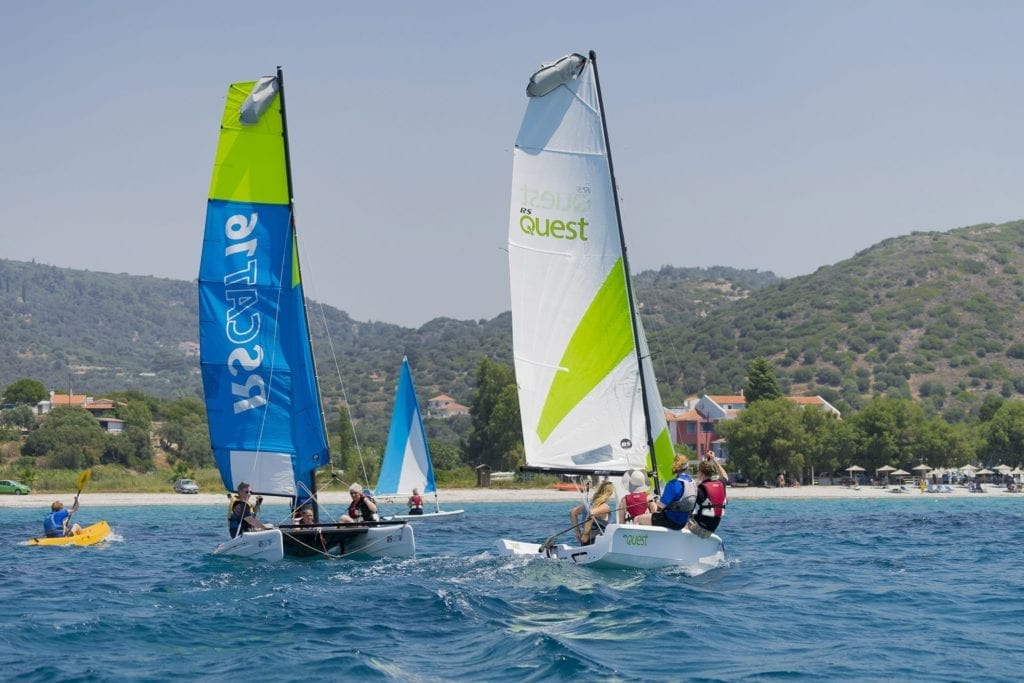 Sailing boats and kayaks racing during the Richmond Regatta in Samos, Greece