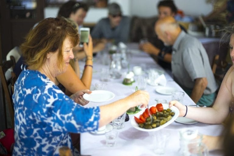 Guests enjoying freshly prepared Greek food in Vourliotes, Samos