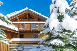 Richmond Holidays' Chalet des Neiges with blue skies and snowy trees