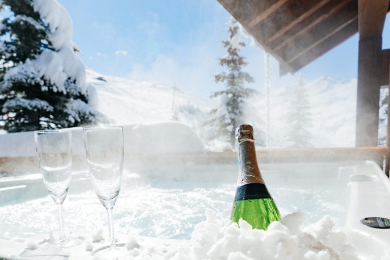 Champagne and two glasses by the hot tub of Chalet des Neiges in the ski holidays resort of the Three Valleys, France