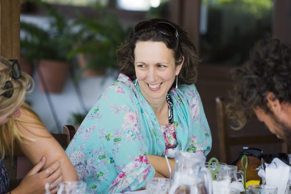 A lady smiling whilst sharing a meal whilst on holiday in Samos, Greece