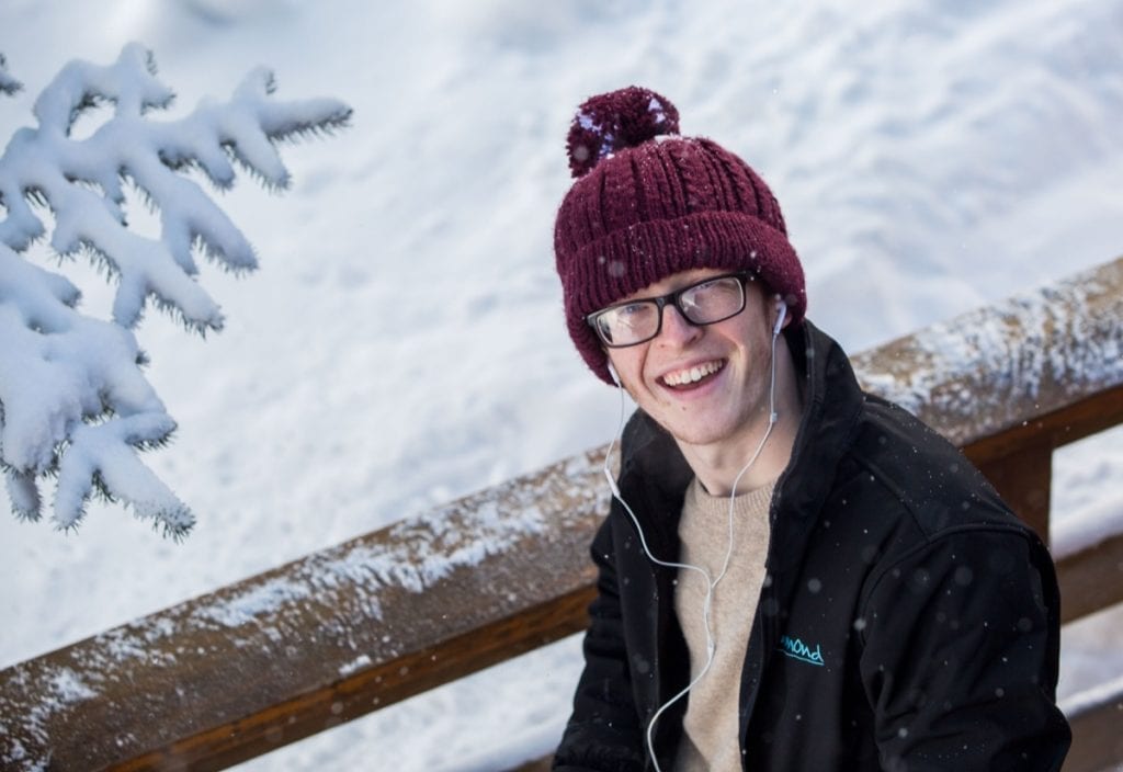 A Richmond staff member taking a break on the balcony of Chalet des Neiges, Reberty