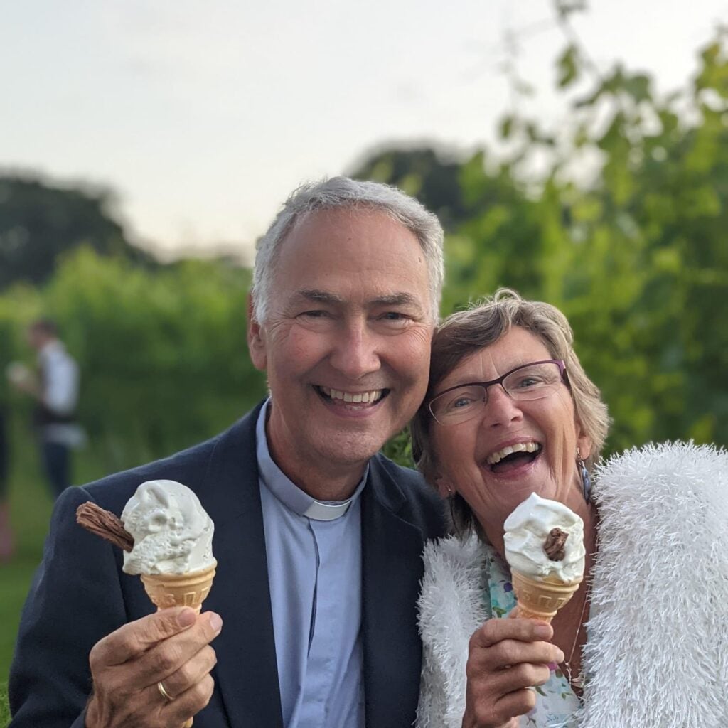 Nick and Pam smiling eating ice creams