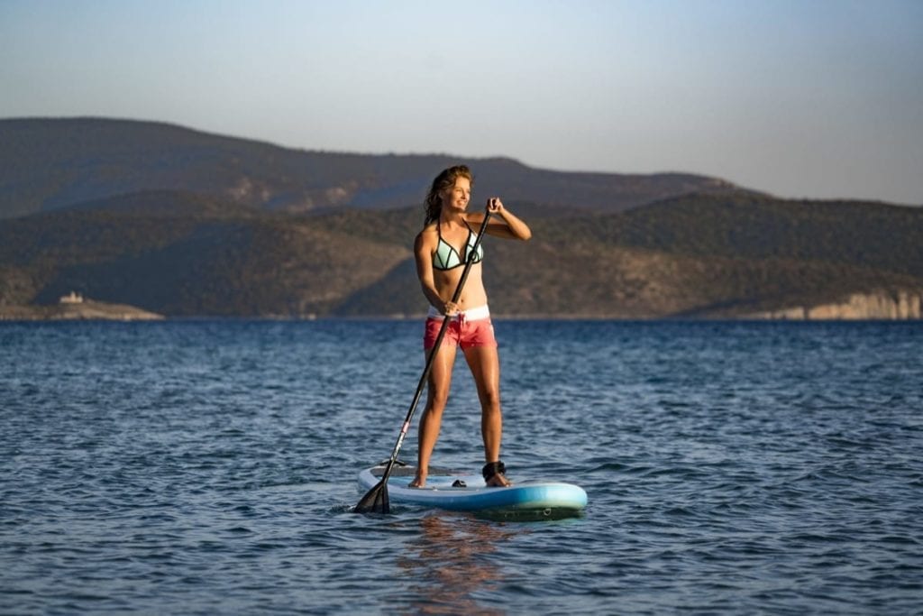 Stand up paddle boarding in Samos, Greece on a summer's evening