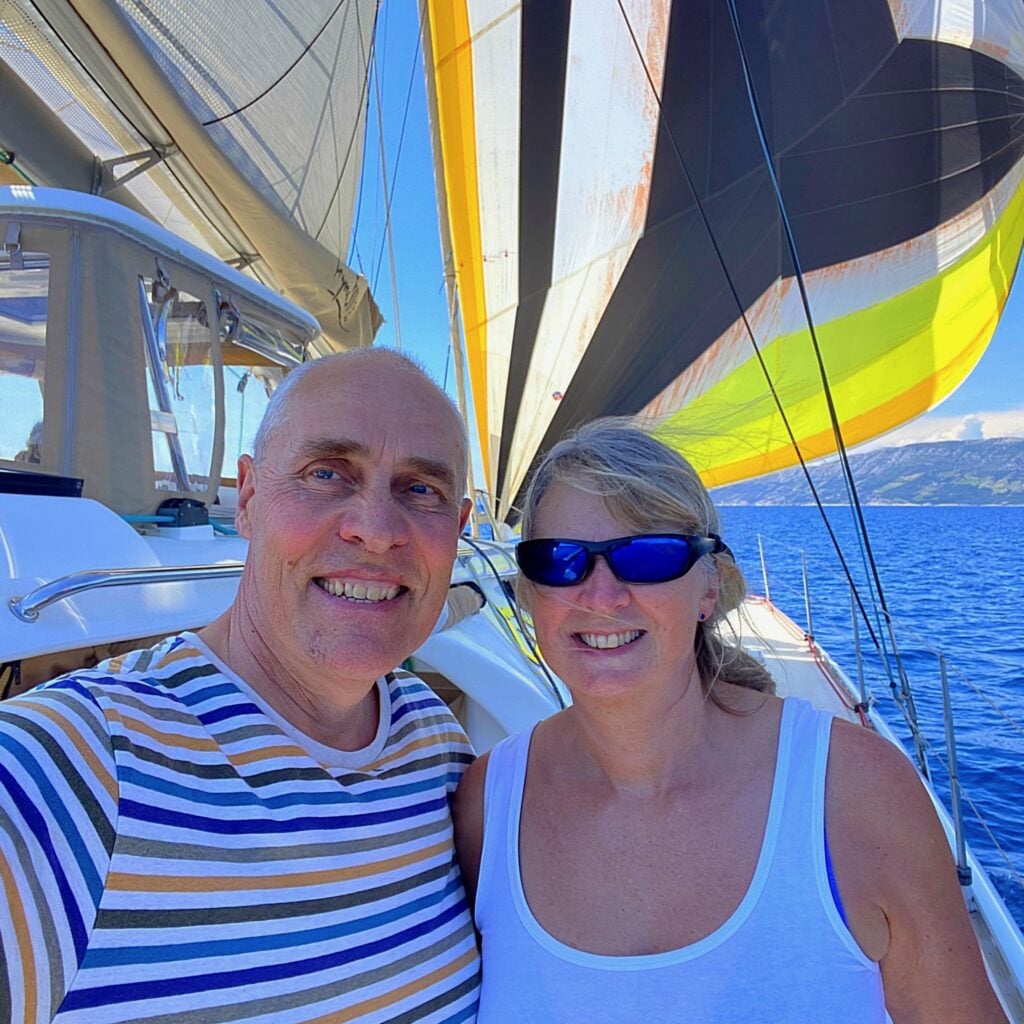 Simon and Rachel Farmer smiling on a yacht