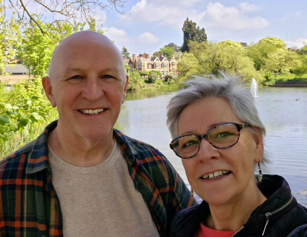 Photo of Malc and Trish Morgan by a sunny river, Richmond ministry leaders