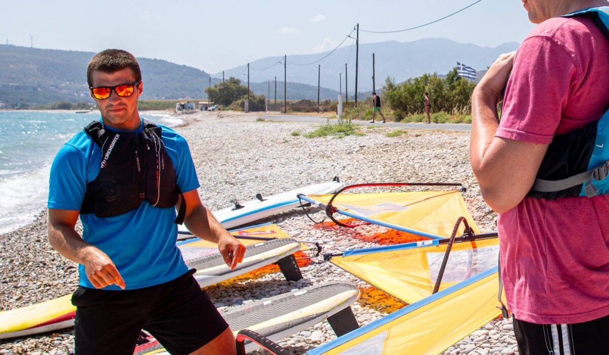 A picture of a Richmond Waterfront team teaching and preparing guests to start their windsurfing on the beach outside the hotel.