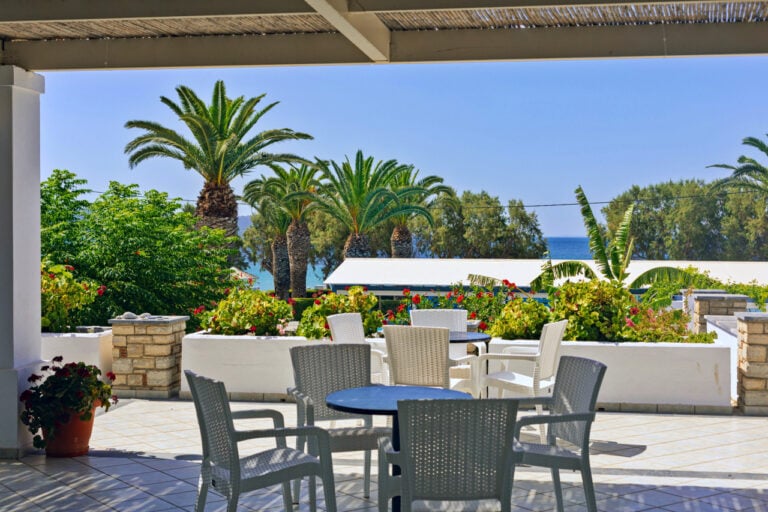 Photo from the veranda displaying the table, chairs and view from the veranda