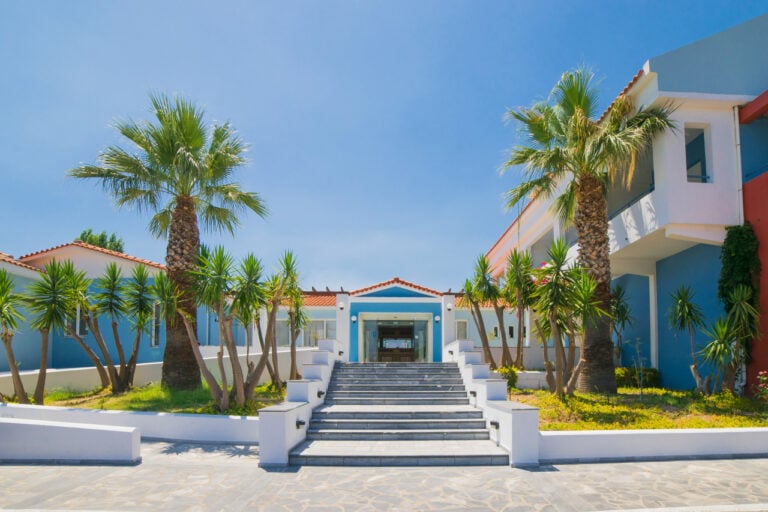 Wide shot of the front of the hotel showing stairs used up to the main entrance