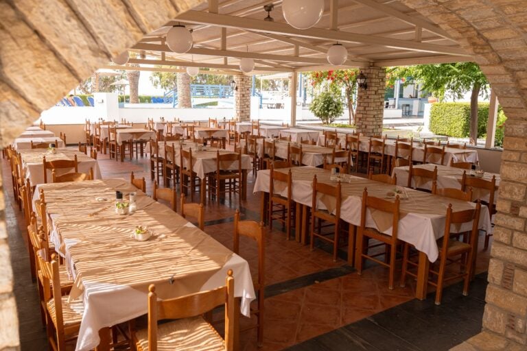 The restaurant area of the hotel with tables and chairs set out in groups of 5 and 6