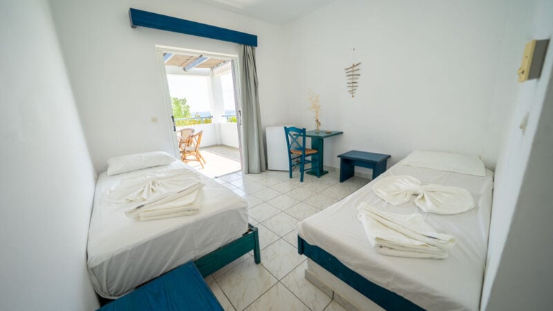 Corner Suite room with two twin beds and balcony with sea views