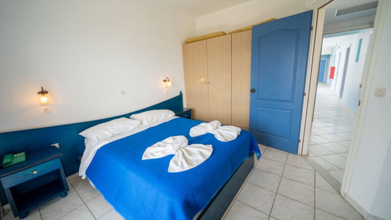 Corner Suite room with double bed, wardrobe space and balcony with sea views.