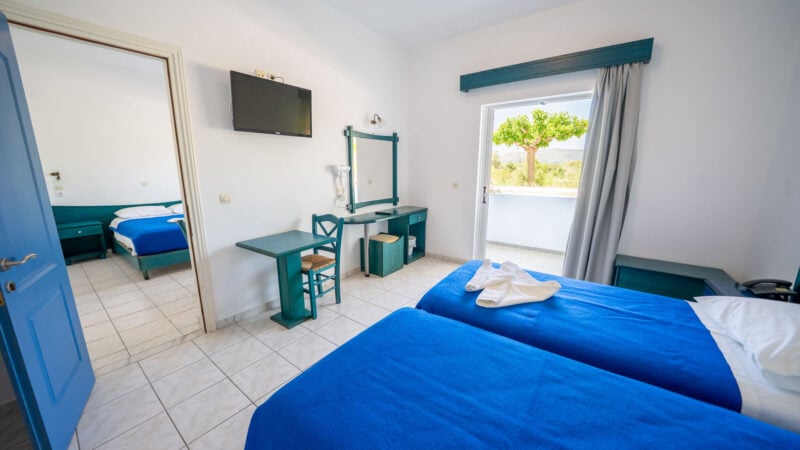 A Lower-Level Room with two twin beds and a private patio with garden views.