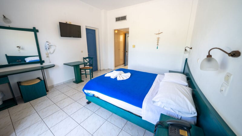 A Lower-Level Room with double bed and a private patio with garden views.