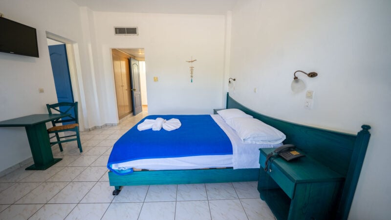 A Lower-Level Room with double bed and a private patio with garden views.