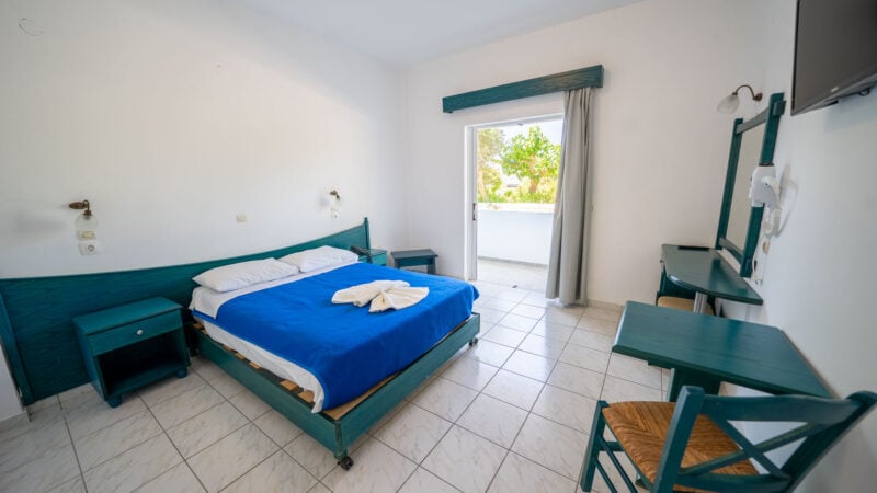 A Lower-Level Room with double bed and a private patio with garden views.