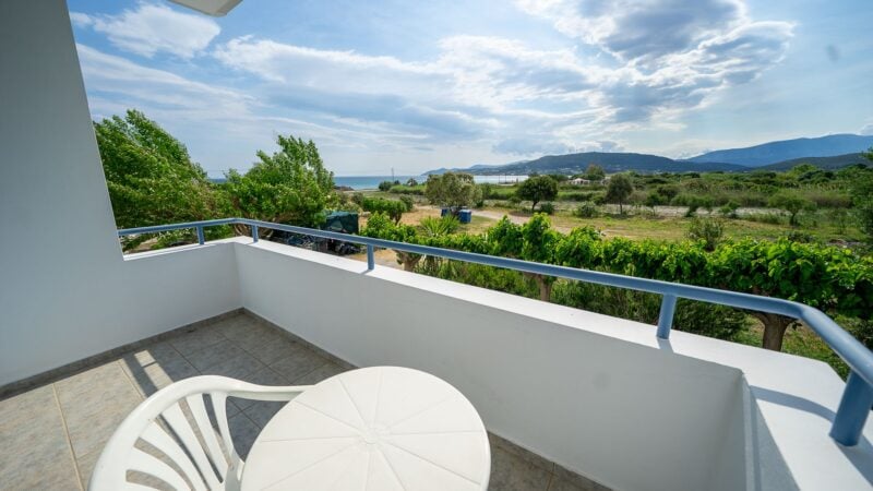 Reception Level balcony with white plastic table and chairs and sea views.