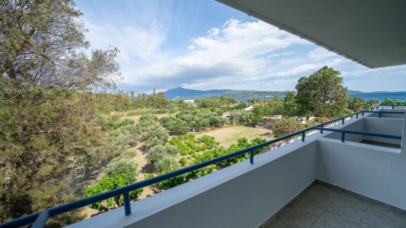 An Upper-Level Room balcony overlooking vegetation with a mountain range