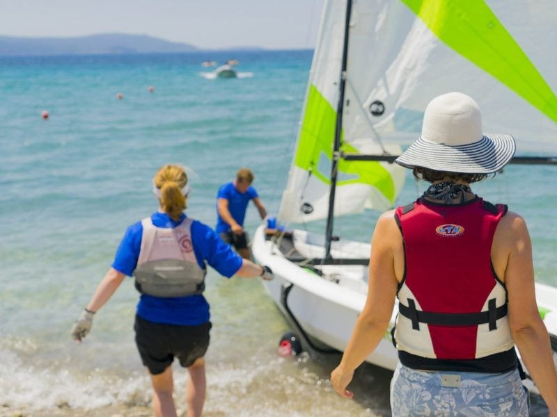Staff taking a boat out for a guest in Samos, Greece